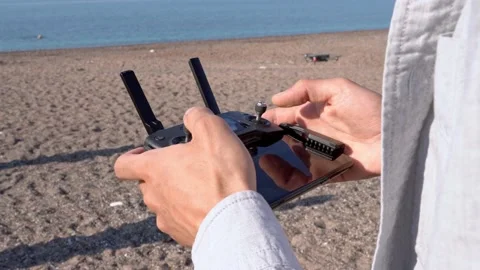 Close up The operator hands a quadcopter control panel in the sunset Against the Stock Footage 194540575