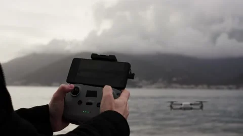Close up of operator holds control panel of the quadcopter against background of 库存影片 236183245