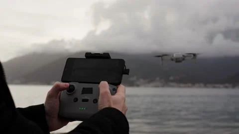 Close up of operator holds control panel of the quadcopter against background of Stock Footage 240054664