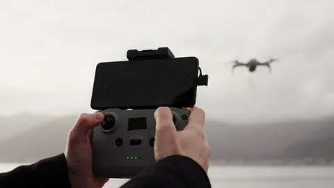 Close up of operator holds control panel of the quadcopter drone against Stock Footage 289019462