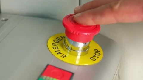 Close-up of operator pressing emergency stop button in industrial factory Stock Footage 325454170