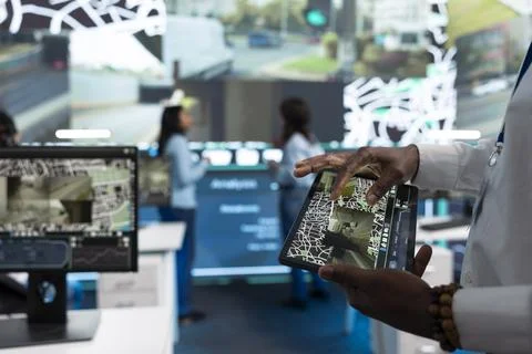 Close up of operator using tablet to look at digital city map and road Stock Photos