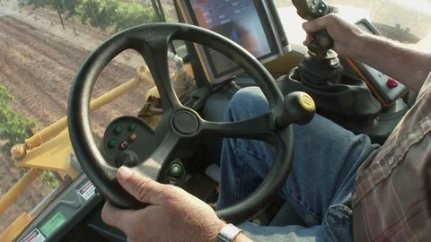 Close of operator's hands on the steering of a farm machine, 4K. Stock Footage 79832407