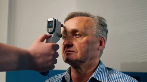 Close up in an ophthalmology clinic checking the pressure of the eyeball of an Stock Footage 276202097