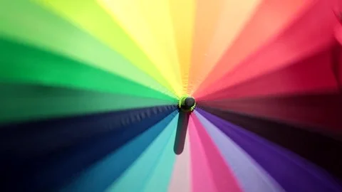 Close-up of optical effect from spinning rainbow multicolored umbrella  Stock Footage 80383240