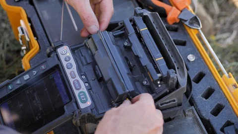 Close-up. Optical line welding machine. Soldering of optic fiber. engineer ISP Stock Footage 128037798