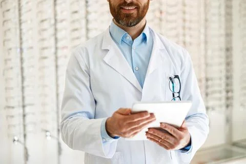 Close up of optician with digital tablet on background of shop windows with Stock Photos