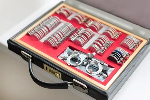 Close-up optometrist trial frame case. Box with different lenses and frame for Stock Photos
