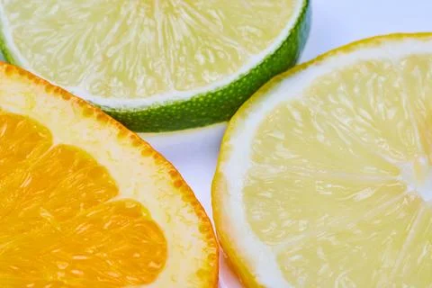 Close up or a lemon slice with orange and lime slices on a white background 스톡 사진