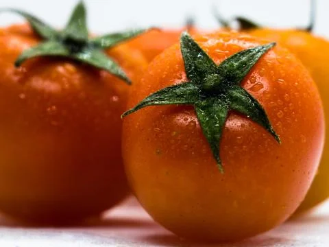Close-up or macro of cherry tomatoes on white background. Stock Photos