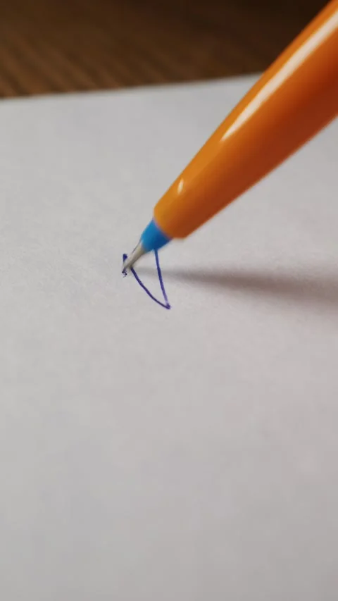 Close Up of Orange Ballpoint Pen Starting to Write on White Paper Stock Footage 339365986