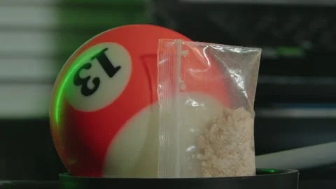 Close-up of an orange billiard ball with "13" next to a small clear Stock Footage 263818903