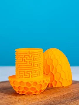 Close up of orange complex maze for storing gift on blue background Stock Photos