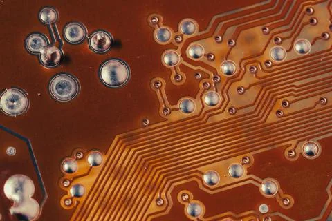 Close up of orange electronic computer circuit board as background Stock Photos