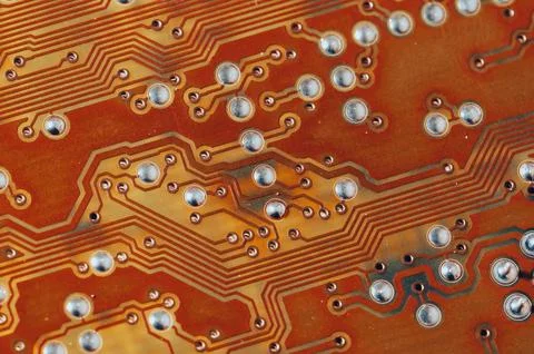 Close up of orange electronic computer circuit board as background Stock Photos