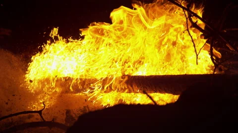 CLOSE UP: Orange flames burn through dry branches and twigs in the pitch black. Stock Footage 139846911