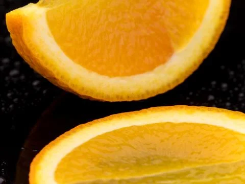 Close-up orange fruit on black surface Stock Photos