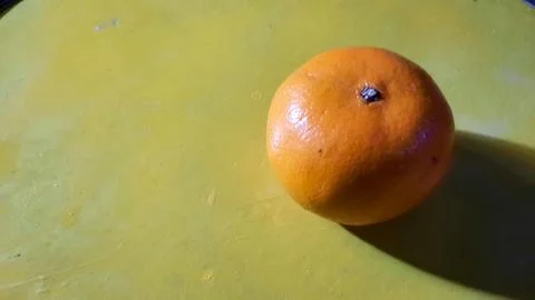 Close up, Orange fruit on a yellow background Stock Photos
