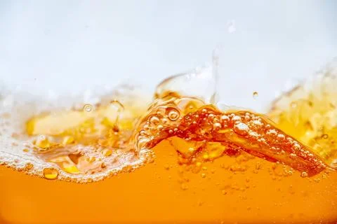 Close-up of orange juice splash with bubbles and pulp Foto stock