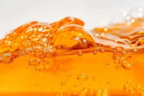 Close-up of orange liquid with bubbles and splash Stock Photos