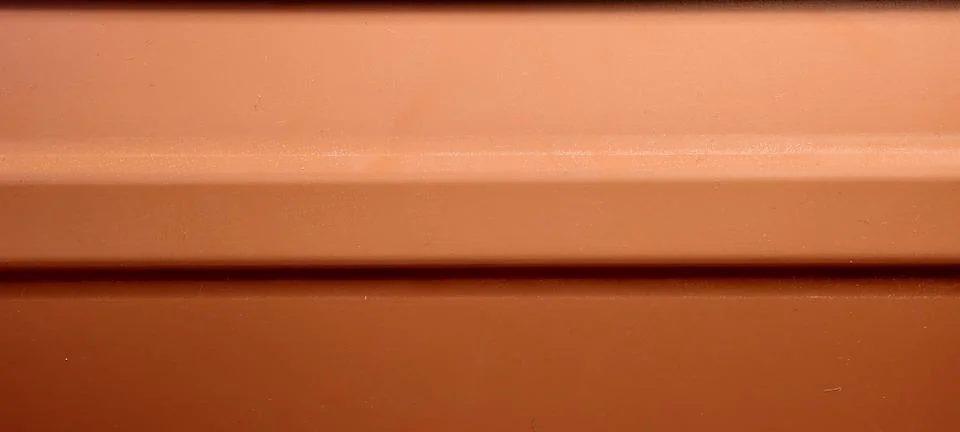 Close‑up of an orange metallic panel Fotos de archivo