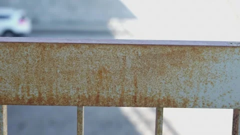 Close up of orange rust on a weathered blue metal railing Stock Footage 332431380
