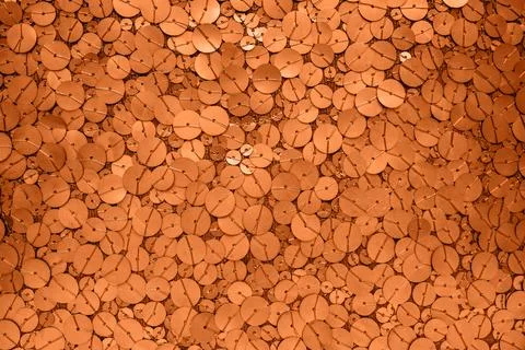 Close-up orange sequin texture background with circular glitter pattern and Stock Photos