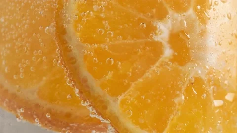 Close-up of orange slices in water with bubbles Stock Footage 186415927