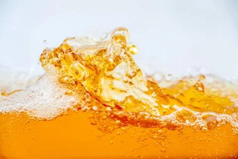 Close-up of orange soda splash with bubbles and foam Stock Photos