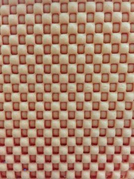 Close-up of orange textured surface with square pattern Stockfoto's