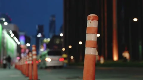 Close-up of orange traffic delineator post with white stripes on the city street Stock-Footage 310164163
