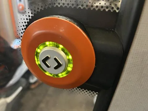 Close-Up Of Orange Train Door Button With Green LED Ring Stock Photos