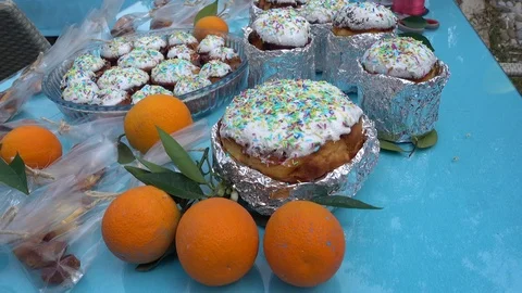 Close up oranges and Easter cakes of different sizes on the table Stock Footage 88309660
