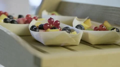 Close Up Orbit Around Shot Of Paper Fruit Boats Full of Variety of Fresh Fruits. Stockbeeldmateriaal 258946054