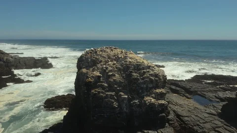 Close Orbit of Rocks Along the Coast of Pichilemu Stock Footage 100640537