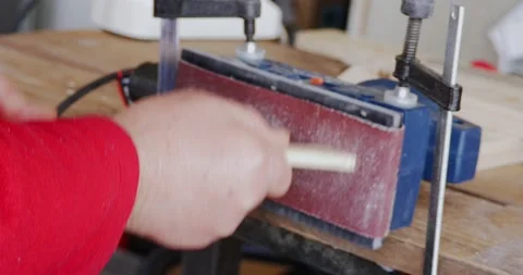 Close-up of orbital sander fixed with clamps on a wooden surface with which a Stock-Footage 152967489