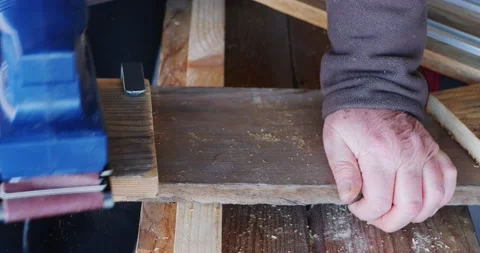 Close-up of orbital sander fixed with clamps on a wooden surface with which a Stock-Footage 157385838
