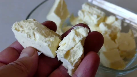 Close-up organic chunks of cheese,human holding feta cheese, 動画素材 166322492