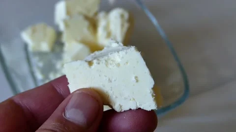 Close-up organic chunks of cheese,human holding feta cheese, Stock Footage 166322709
