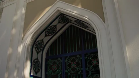 Close-up of Ornate Arched Window with Decorative Tiles and Bars Stock Footage 338243942
