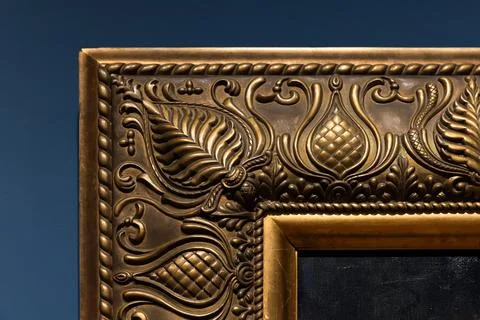Close-up of an ornate gilded frame corner, featuring scrolling leaves and f.. Stock Photos