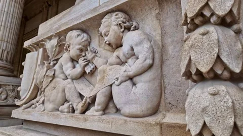 Close-up of ornate stone relief featuring cherubs at Grand Palais in Paris Stock Footage 304577587