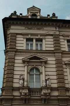 Close-up of ornate window with classical statues on a historic building in Novi Stock Photos