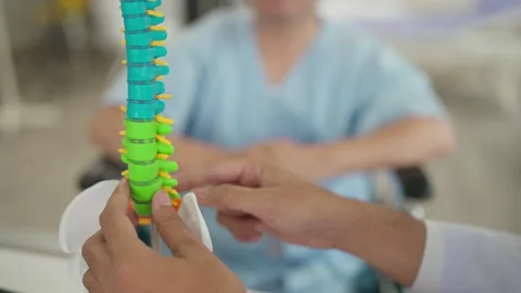 Close up orthopedic spine model while doctor explaining a back injury to patient Stock Footage 265059246