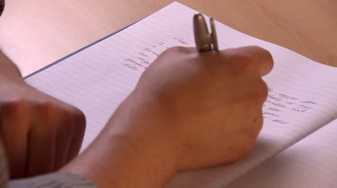 Close OTS Shot of Someone Writing in Notebook Stock Footage 48685412