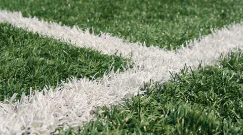 Close up of the out of bounds line on a turf football field Stock Footage 66240884