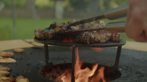 Close-up with out-of-focus cooking of meat on a summer barbecue grill Stock Footage 249175146