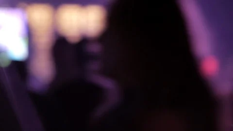 Close up out of focus people dancing in club colored lights flares 動画素材 103967571