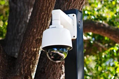 Close-up of an outdoor dome security camera mounted on a pole Photos