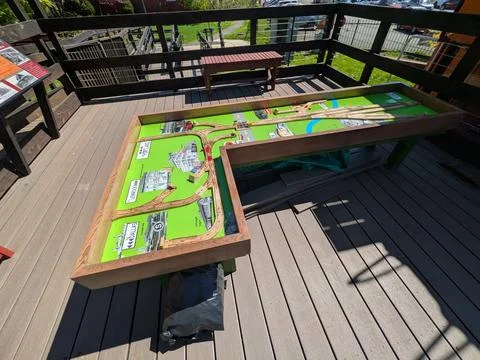 Close-up of an outdoor educational display featuring wooden train tracks 写真素材